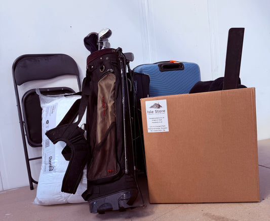 Golf bag with clubs, a cardboard box, and other large items ready for door to door storage.
