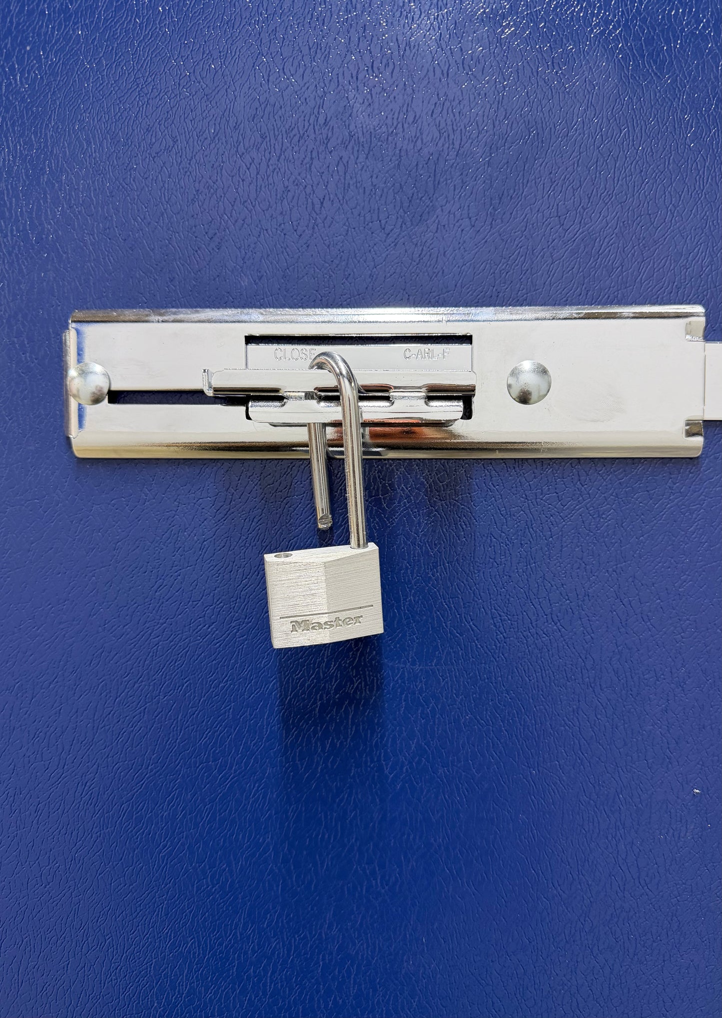 A close-up of a customer's heavy-duty padlock securing the locked metal door of their Isle Store self-storage unit in Cowes.