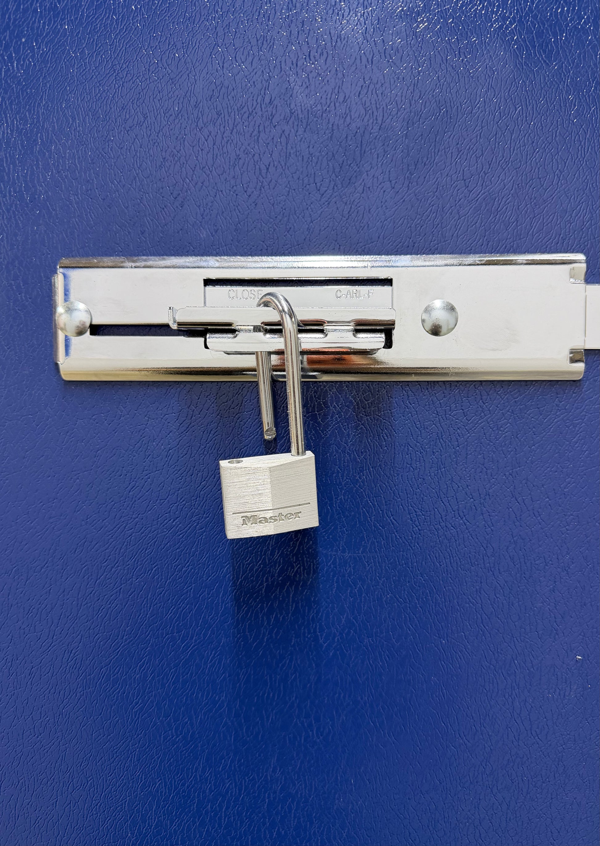 A close-up of a customer's heavy-duty padlock securing the locked metal door of their Isle Store self-storage unit in Cowes.