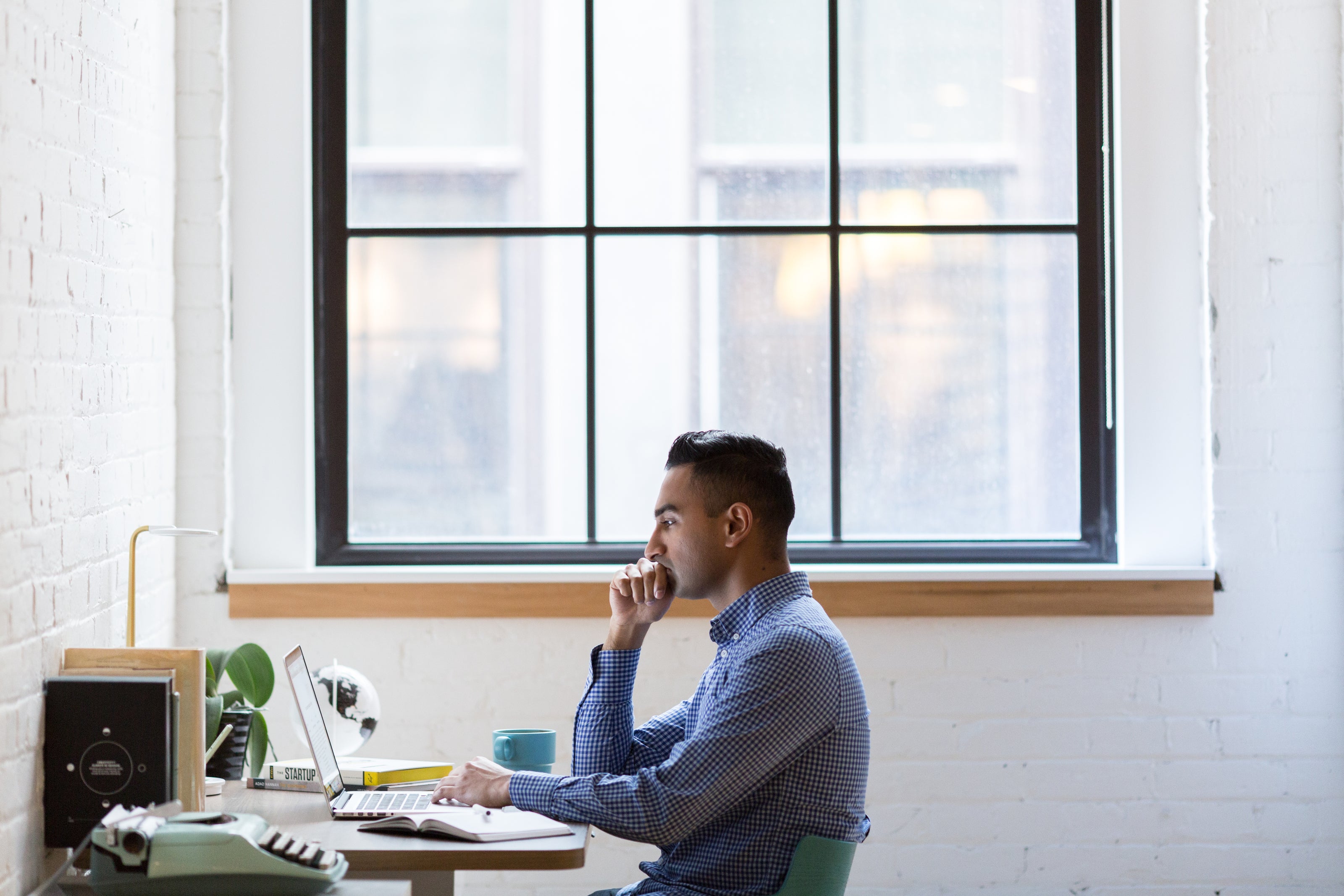 An office worker in a professional workspace, representing modern business management.